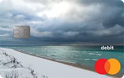 A photograph of the Great Lakes in winter by Nine Design + Homes is imposed on our Mastercard debit cards