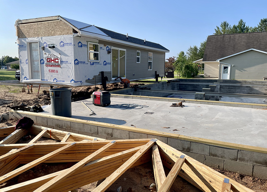 Photo of Habitat for Humanity dump truck at new construction site in Hillman, Michigan