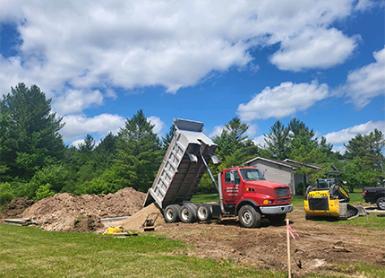 Photo of Habitat for Humanity dump truck at new construction site in Hillman, Michigan